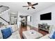 Spacious living room featuring hardwood floors, comfortable seating, and seamless dining area access at 7544 Rolling Meadows Ln, Huntersville, NC 28078