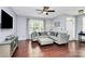 Comfortable living room boasts hardwood floors, modern decor, and large window at 7544 Rolling Meadows Ln, Huntersville, NC 28078
