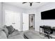 Comfortable living room with gray seating, desk, television, and open door view to bath at 7544 Rolling Meadows Ln, Huntersville, NC 28078