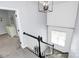 Bright staircase with an open concept view, modern light fixture and view into a bedroom at 7544 Rolling Meadows Ln, Huntersville, NC 28078