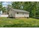 Backyard with a grassy area, wooden deck, and mature trees at 772 Austin Rd, New London, NC 28127