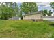 Spacious backyard featuring the house, a detached garage, and a trampoline at 772 Austin Rd, New London, NC 28127