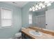 Well-lit bathroom with a shower, large mirror, and sink with countertop space at 772 Austin Rd, New London, NC 28127