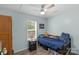 Cozy bedroom with a window, ceiling fan, closet and wooden bed frame on hardwood floors at 772 Austin Rd, New London, NC 28127