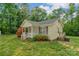 Well-maintained home showcasing lush greenery and a cozy side entrance at 772 Austin Rd, New London, NC 28127