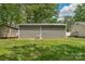 A detached metal garage in a well-maintained backyard at 772 Austin Rd, New London, NC 28127