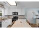 Well-lit kitchen with white cabinetry, stylish backsplash, and modern appliances for a functional cooking space at 772 Austin Rd, New London, NC 28127