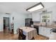 Bright kitchen with stainless steel refrigerator, eat-in table, white cabinets and view of the doorway to the hall at 772 Austin Rd, New London, NC 28127
