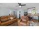 Cozy living room with a ceiling fan, leather furniture, and an open layout leading into the kitchen at 772 Austin Rd, New London, NC 28127