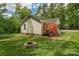Backyard view with mature trees, a fire pit, and home at 772 Austin Rd, New London, NC 28127