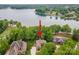 Aerial shot features a waterfront property, lush landscaping, and stunning lake views at 8216 Malibu Pointe Ln, Denver, NC 28037