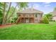 Brick two-story home with a large backyard and a second-story deck at 8216 Malibu Pointe Ln, Denver, NC 28037