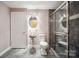 Bathroom featuring a modern metal sink, round mirror and glass door shower at 8216 Malibu Pointe Ln, Denver, NC 28037