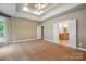 Bright main bedroom features neutral carpet, tray ceiling and access to main bathroom at 8216 Malibu Pointe Ln, Denver, NC 28037