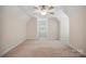 Neutral bedroom features an angled ceiling, neutral carpeting, and a single window at 8216 Malibu Pointe Ln, Denver, NC 28037