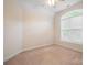 Empty bedroom features neutral carpet and a large arched window with views of the outdoors at 8216 Malibu Pointe Ln, Denver, NC 28037