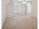 Angled ceilings enhance this bright bedroom featuring neutral paint and carpet and a large window at 8216 Malibu Pointe Ln, Denver, NC 28037