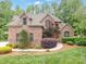 Beautiful brick home featuring a meticulously landscaped front yard and inviting curb appeal at 8216 Malibu Pointe Ln, Denver, NC 28037