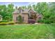 Charming brick home with lush landscaping and mature trees in a serene, picturesque setting at 8216 Malibu Pointe Ln, Denver, NC 28037