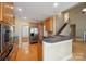 Open kitchen with wood cabinets, stainless appliances, and easy access to living areas and lake views at 8216 Malibu Pointe Ln, Denver, NC 28037