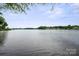 Scenic view of the calm lake waters, framed by lush greenery and distant shorelines at 8216 Malibu Pointe Ln, Denver, NC 28037