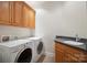 Well-lit laundry room features a countertop, sink, and a washer and dryer at 8216 Malibu Pointe Ln, Denver, NC 28037