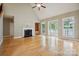 Bright living room with a fireplace, hardwood floors, and access to an outdoor deck with lake views at 8216 Malibu Pointe Ln, Denver, NC 28037