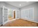 Well-lit office space featuring large windows, shutter blinds, and glass French doors at 8216 Malibu Pointe Ln, Denver, NC 28037
