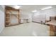 Large storage room with a workshop space, cabinets, work tables, and white walls at 8216 Malibu Pointe Ln, Denver, NC 28037