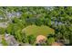 An aerial view of a baseball field in a neighborhood surrounded by trees and residential buildings on a sunny day at 862 Mcalway Rd, Charlotte, NC 28211