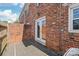 Brick patio and wall, accessed through glass patio doors, offer a private outdoor space at 862 Mcalway Rd, Charlotte, NC 28211