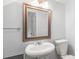 Bathroom featuring white pedestal sink and a decorative mirror at 862 Mcalway Rd, Charlotte, NC 28211