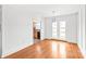 Dining room with hardwood floors offers a view into the kitchen and outdoor access via patio doors at 862 Mcalway Rd, Charlotte, NC 28211