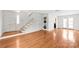 Open-concept living space with hardwood floors, staircase and modern stacked washer dryer at 862 Mcalway Rd, Charlotte, NC 28211