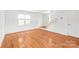 Inviting living room boasts pristine white walls, hardwood flooring, and ample natural light at 862 Mcalway Rd, Charlotte, NC 28211