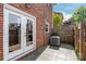 Cozy brick patio with a privacy fence and access to the house through double glass doors at 862 Mcalway Rd, Charlotte, NC 28211