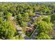 An aerial view of a charming brick home with mature landscaping, surrounded by lush greenery and estimated property lines at 961 Confederate Ave, Salisbury, NC 28144