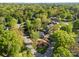 An aerial view of a charming brick home with mature landscaping, surrounded by lush greenery and estimated property lines at 961 Confederate Ave, Salisbury, NC 28144