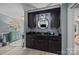 Stylish bar area with black cabinetry, a decorative backsplash, and modern fixtures for entertaining at 961 Confederate Ave, Salisbury, NC 28144