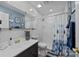 Bathroom featuring marble tile, modern sink, shower, and gold fixtures at 961 Confederate Ave, Salisbury, NC 28144