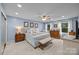 Bright bedroom with carpet, blue walls, windows with natural light, and wood furniture at 961 Confederate Ave, Salisbury, NC 28144