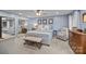 This is a beautiful bedroom that is carpeted and includes a ceiling fan and a bench at 961 Confederate Ave, Salisbury, NC 28144