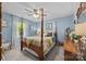 A bright bedroom with hardwood floors, large window, and a traditional four poster bed at 961 Confederate Ave, Salisbury, NC 28144
