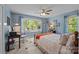 A cozy bedroom with hardwood floors, large window and natural light, and ceiling fan at 961 Confederate Ave, Salisbury, NC 28144