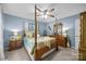 Bedroom features a four poster bed, hardwood floors, blue walls, and traditional furnishings at 961 Confederate Ave, Salisbury, NC 28144