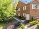 Brick home with a well-kept side yard featuring garden beds and a walkway leading to a side entrance at 961 Confederate Ave, Salisbury, NC 28144