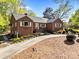 Inviting brick home showcasing a well-manicured lawn, garden beds, and a welcoming front entrance at 961 Confederate Ave, Salisbury, NC 28144