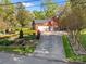 Brick home with an attached garage and a long driveway, complemented by manicured landscaping at 961 Confederate Ave, Salisbury, NC 28144