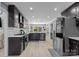 Spacious kitchen featuring dark cabinetry, stainless steel appliances, and a breakfast bar for casual dining at 961 Confederate Ave, Salisbury, NC 28144