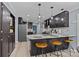 Modern kitchen with dark cabinets, a stainless steel refrigerator, and a breakfast bar with seating at 961 Confederate Ave, Salisbury, NC 28144